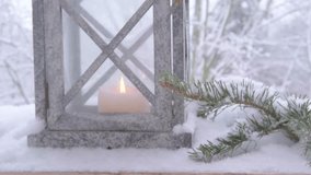 cozy Christmas scene with glowing candle in garden lantern lights up snowy scene, female hands holding winter decoration, perfect for bringing Christmas cheer to winter décor - Powered by Shutterstock - Get 15% off with code: PIKWIZARD15
