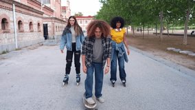Young friends enjoying skating and skateboarding together in a city park, showcasing youthful energy and urban leisure in slow motion - Powered by Shutterstock - Get 15% off with code: PIKWIZARD15