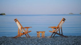 Two wooden empty loungers on the beach, blue tranquil sea - Powered by Shutterstock - Get 15% off with code: PIKWIZARD15