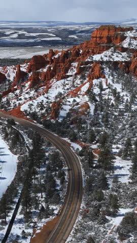 Road Along The Bryce Canyon National Park In Winter In Utah, USA. - aerial vertical shot