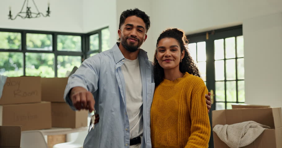 Happy family, face and hug with keys in new home for relocation, safety and security together. Portrait, man and woman with smile or access for property investment, sale or buy in apartment or house