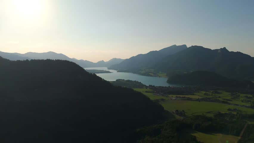 Aerial: Lake Wolfgang and Strobl am Wolfgangsee in the Salzburg Alps region in the late afternoon in Austria, pan drone shot