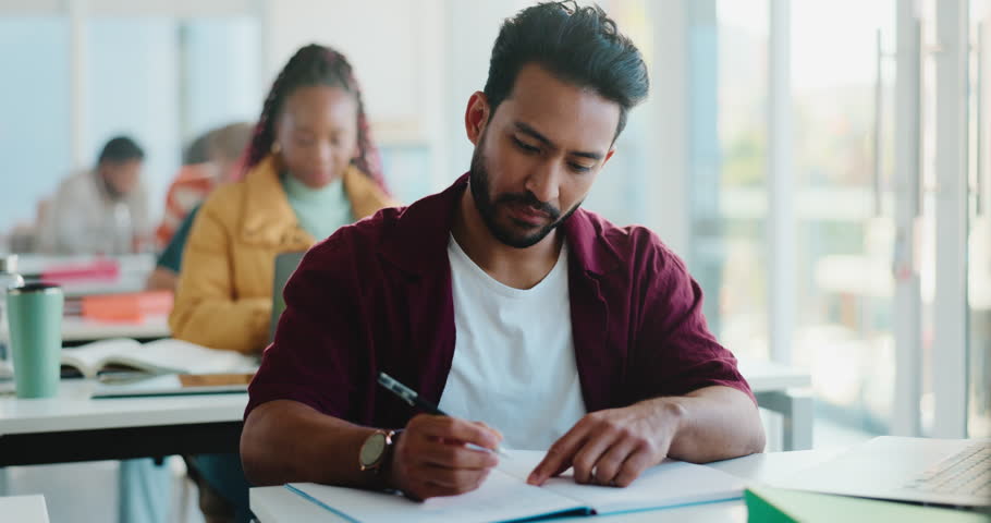 Notebook, thinking and man in college for exam, assignment or knowledge development in test. Students, people and English assessment in classroom with education, course essay and research notes