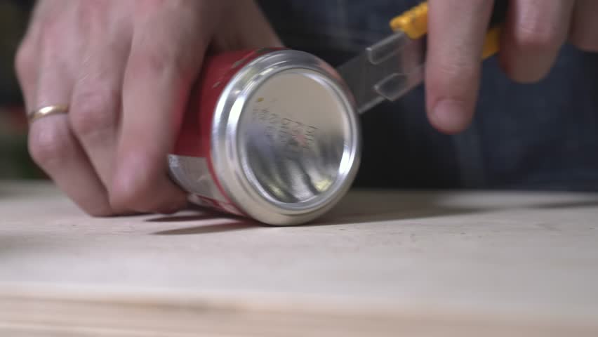 the worker laser cuts out parts of wood, makes a roof from an aluminum can, paints and patinas the future walls, glues everything together into one structure and the result is a miniature farmhouse