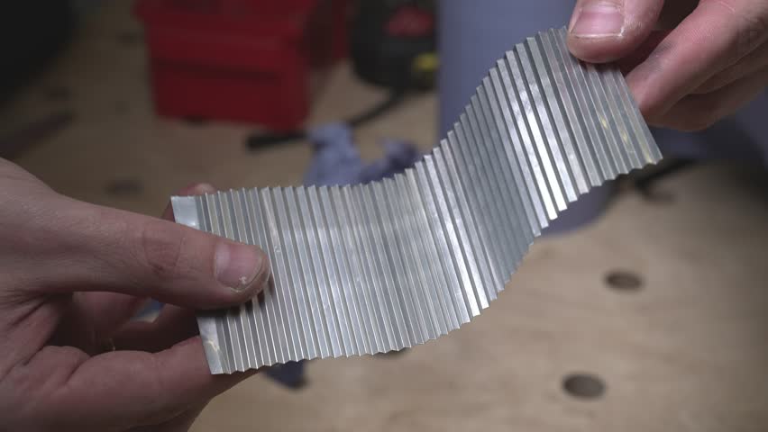 the worker laser cuts out parts of wood, makes a roof from an aluminum can, paints and patinas the future walls, glues everything together into one structure and the result is a miniature farmhouse