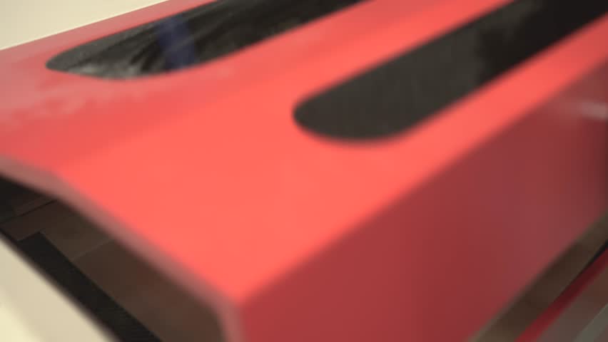 the worker laser cuts out parts of wood, makes a roof from an aluminum can, paints and patinas the future walls, glues everything together into one structure and the result is a miniature farmhouse