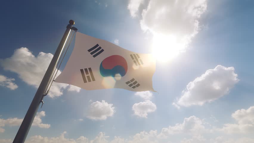 South Korea Flag on a Flagpole with a cloudy blue sky background