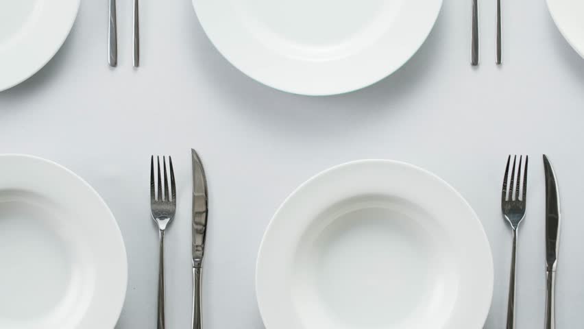 Elegant table setting with white tableware plates, cutlery, and glassware for a classy dining, fancy expensive restaurant dinner - Powered by Shutterstock - Get 15% off with code: PIKWIZARD15