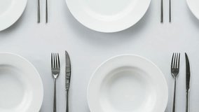 Elegant table setting with white tableware plates, cutlery, and glassware for a classy dining, fancy expensive restaurant dinner - Powered by Shutterstock - Get 15% off with code: PIKWIZARD15
