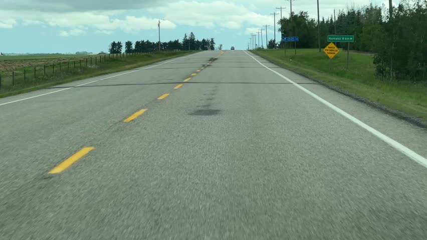 Driving on the Open Highway Through Rural Countryside in Alberta, Canada
