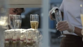 Bartender pouring champagne into flute glasses outdoors - Powered by Shutterstock - Get 15% off with code: PIKWIZARD15