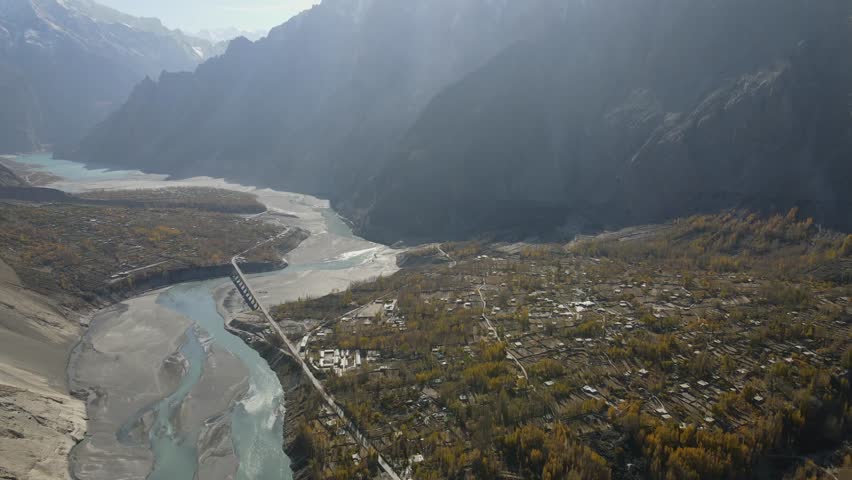 Aerial view of mountains and river in picturesque valley, Pakistan.