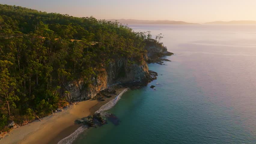 Aerial view of cliffs and beach at sunrise, Australia.