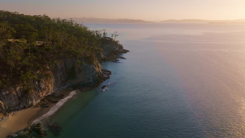 Aerial view of cliffs and beach at sunrise, Australia.