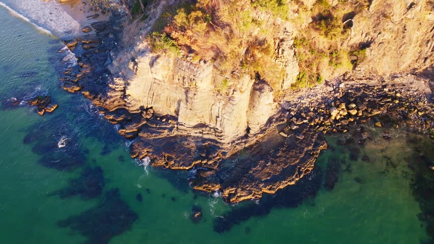 Aerial view of cliffs and beach at sunrise, Australia.