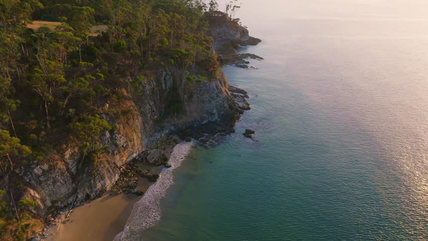 Aerial view of cliffs and beach at sunrise, Australia.
