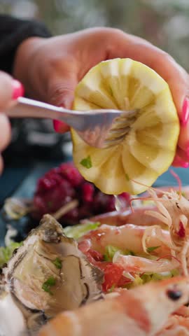 Woman Squeezing A Lemon With The Fork During Lunch At The Beach Resort 