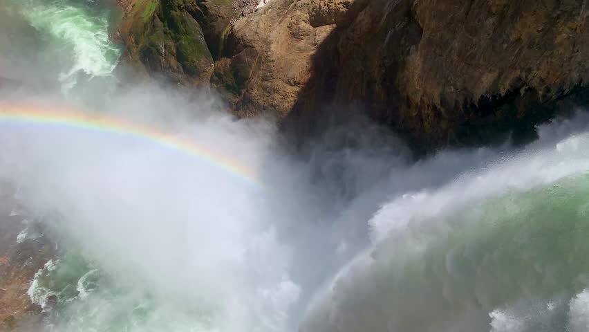 Yellowstone National Park Brink of the Lower Falls rainbow. Cliff edge view of powerful waterfall