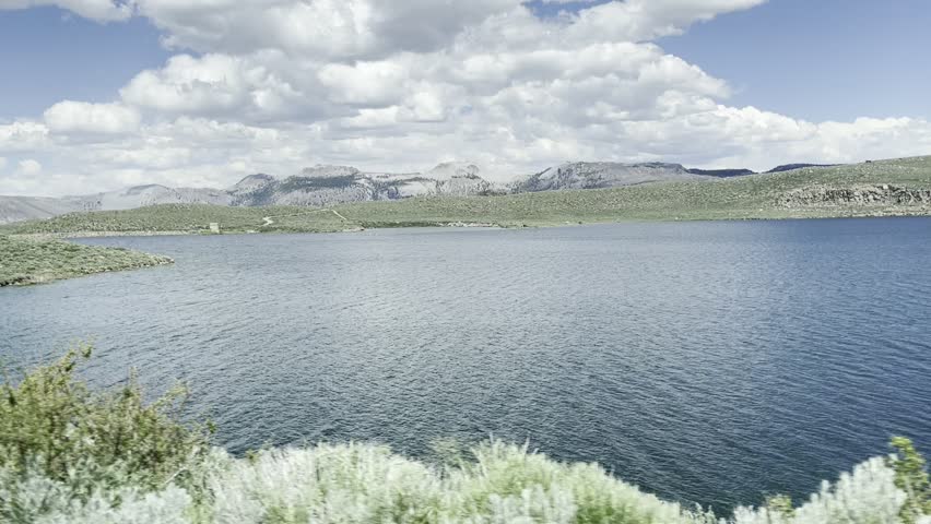 Mountain Lake Vista with Rugged Peaks and Cloudy Sky