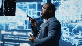 Young black businessman having a conversation on phone call, sharing insight on artificial intelligence systems and machine learning. IT engineer chatting about neural networks. Camera B. - Powered by Shutterstock - Get 15% off with code: PIKWIZARD15