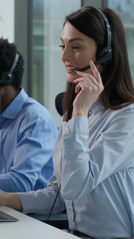 Three diverse business people multiethnic Indian women African man call center service operators work indoor office talking client headset on computer sales agents support sell online at callcenter
