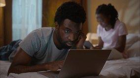 African American family couple working laptop digital tablet evening at home bedroom ethnic married wife husband using computer typing device online gadget addiction shopping reading news indoor night - Powered by Shutterstock - Get 15% off with code: PIKWIZARD15