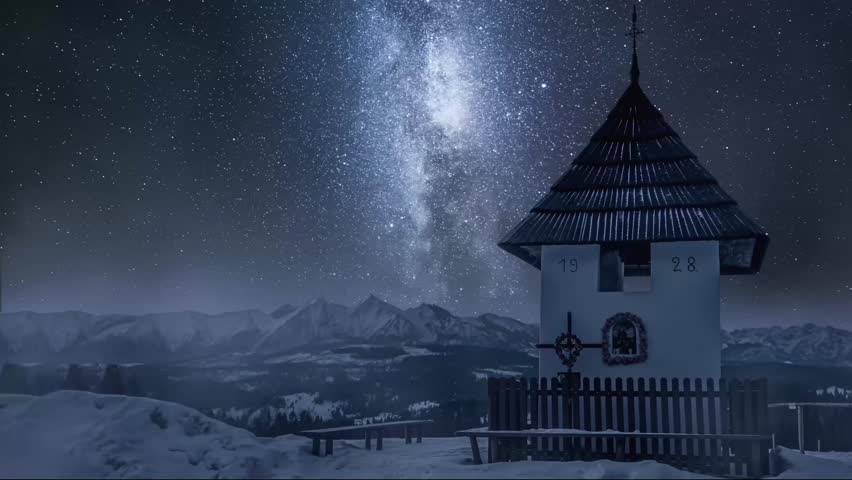 Beautiful night timelapse of Milky Way galaxy shining above a snowy mountain hut. Winter landscape with traditional architecture under starry sky in alpine region, peaceful and mesmerizing view.