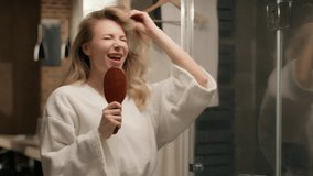 Happy Caucasian woman singing hairbrush music song having fun bathroom morning cheerful female model sing comb brush dancing microphone karaoke shower routine girl enjoy brushing hair beauty at bath - Powered by Shutterstock - Get 15% off with code: PIKWIZARD15