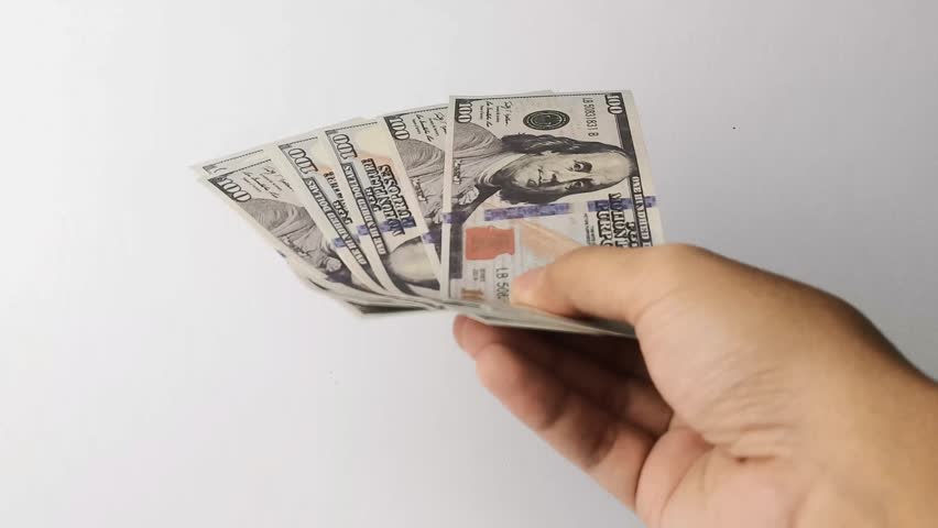 man giving a bunch of dollar bills white background
