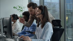 Multiethnic callcenter teamwork support service Caucasian man manager tablet pointing screen headset helpdesk woman employee African Indian coworkers call center office operators sale consult training - Powered by Shutterstock - Get 15% off with code: PIKWIZARD15