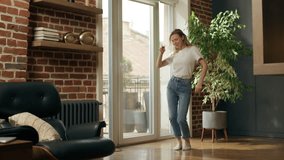 Joyful energetic Caucasian woman girl having fun dancing at home morning energy mood excited businesswoman female celebrate jumping dance music party rejoicing carefree weekend relax indoor apartment - Powered by Shutterstock - Get 15% off with code: PIKWIZARD15