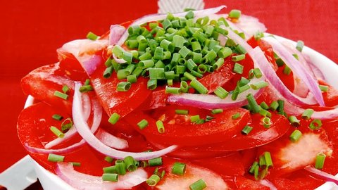 vegetable salad : fresh tomato salad with onion and chives in white bowl over red cloth 1920x1080 intro motion slow hidef hd