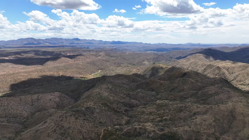 Aerial view of mountains and desert under blue sky, United States.
