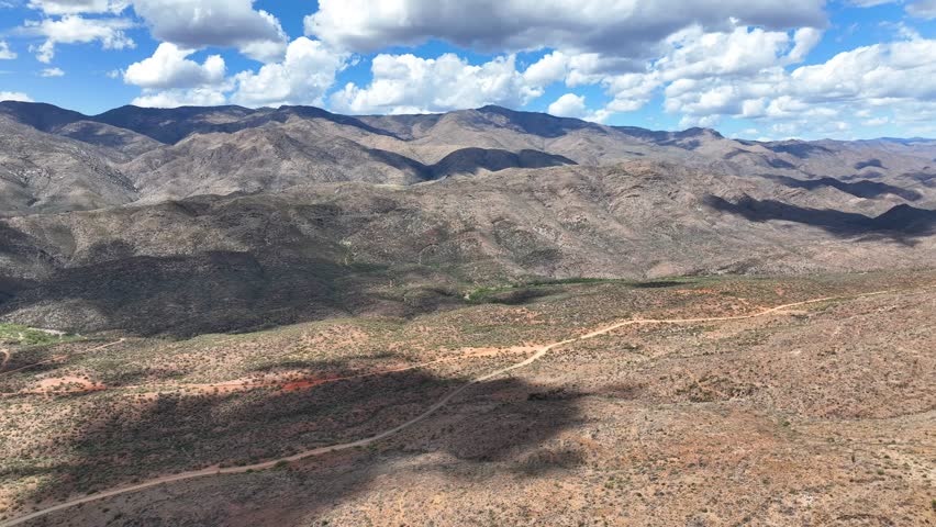 Aerial view of mountains and desert under blue sky, United States.