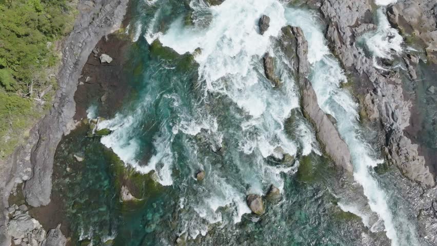 Aerial view of wild river with rocks and rapids