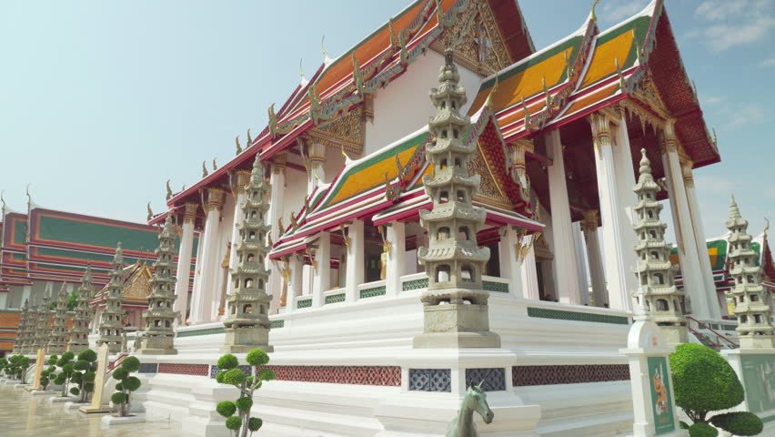 Awesome view of Wat Suthat Thepwararam in Bangkok, Thailand. The Buddhist temple is a landmark of Bangkok and a popular tourist attraction of Thailand.