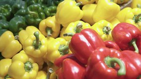 Closeup view of fresh bell peppers in a grocery store. Ripe green, red and yellow vegetables. Sweet pepper is a healthy vegetarian food. Product of organic farming. - Powered by Shutterstock - Get 15% off with code: PIKWIZARD15