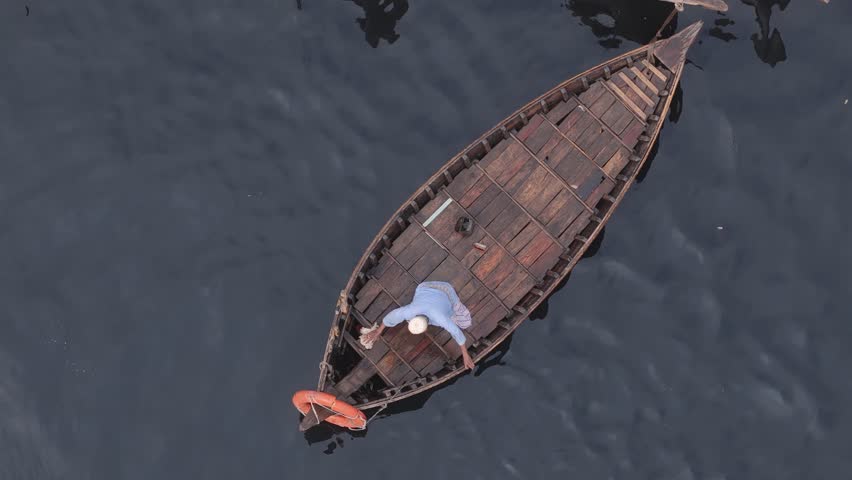 Dhaka, Bangladesh - 01 April 2025: Aerial view of wooden boats on a calm river, Bangladesh.