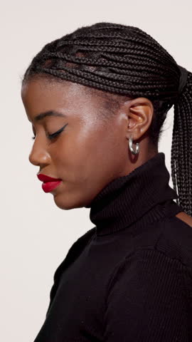 Black woman, face and makeup in studio for beauty, style confidence and aesthetic. Person, cosmetics and red lipstick on white background with eyelash extension, hair braids and designer fashion