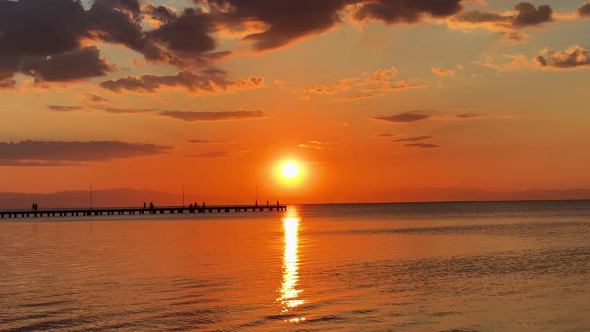Sunset over Mediterranean sea Greece calm beautiful big orange sun setting
