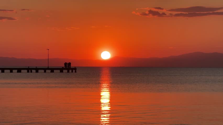 Sunset over Mediterranean sea Greece calm beautiful big orange sun setting