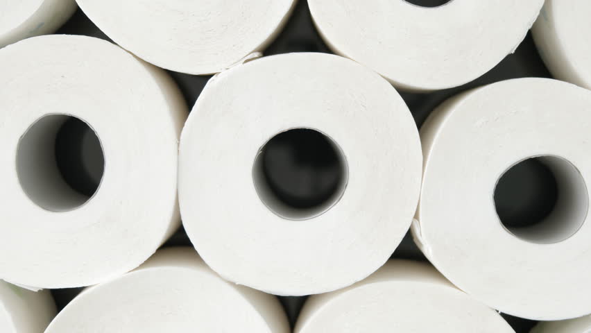 Toilet paper roll spins on dark turntable with crisp lighting and clear top-down symmetry, for hygiene product promo