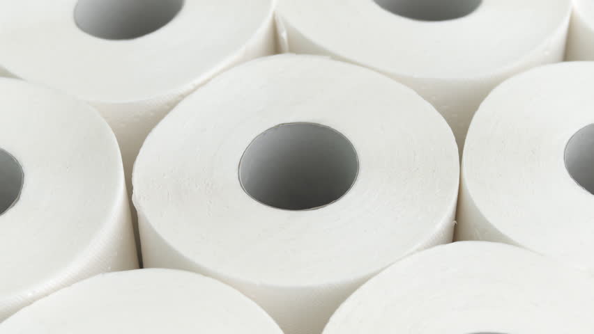 White toilet paper roll rotates on mechanical base with smooth lighting and gray background, for hygiene product promo
