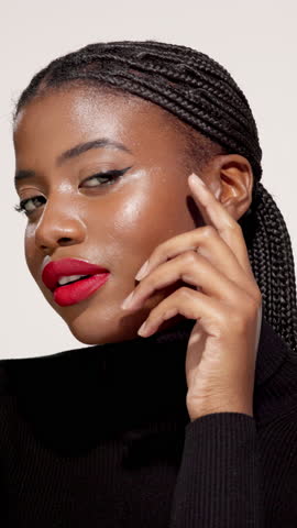 Black woman, face and cosmetics in studio for beauty, style confidence and aesthetic. Female person, makeup and red lipstick on white background with eyelash extension, hair braids and touch skin