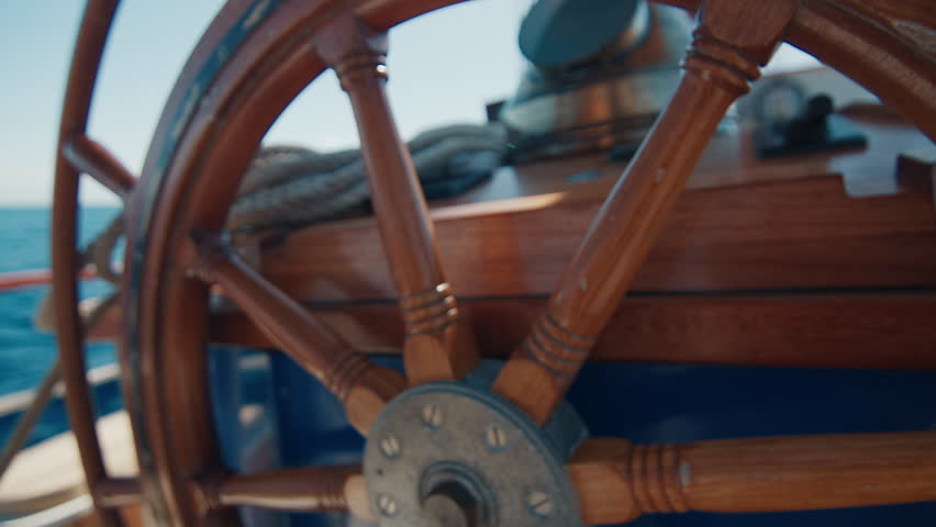 Sailing boat moves in the sea. Deck with helm on a retro sailing boat