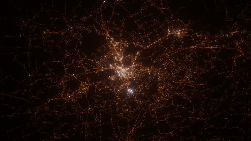 Concord (New Hampshire, USA) top view at night. Top view on modern city with street lights and glow effect. Camera is zooming in, rotating clockwise. Vertical video. The north is on the left side
