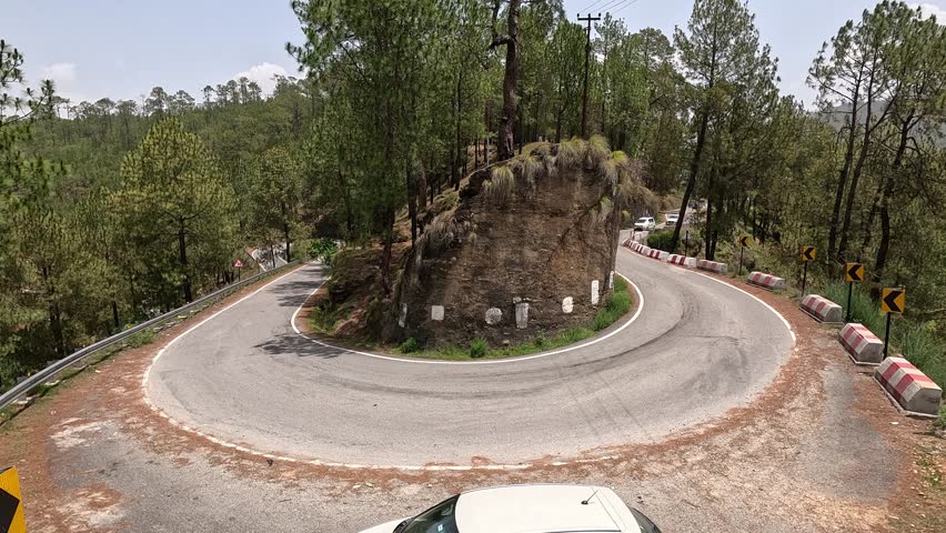 Scenic Mountain Road with Cars and Pine Trees