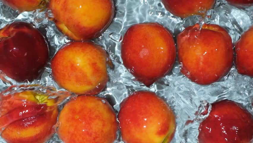 Top View of Ripe Peaches Floating in Water with Ripples Slow Motion - Powered by Shutterstock - Get 15% off with code: PIKWIZARD15