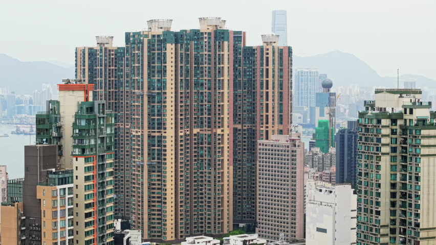 Urban Landscape Of Hong Kong Revealing Dense Residential High-Rises Stretching Toward Sea, Representing City