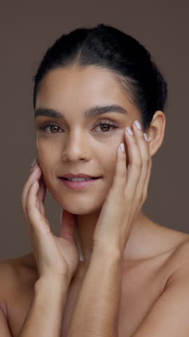 Skincare, beauty and face of woman in studio with glowing skin, hydration and collagen treatment. Clean, person and happy with cosmetics on brown background for dermatology, self care and wellness